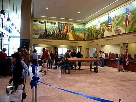 A part of the very large crowd that came for the open house. The left panel and a portion of the central panel of the Mural is shown.