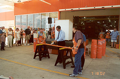 Officiating at the opening ceremony ribbon cutting, or more precisely, board cutting, was City Council member Terry Sanders.