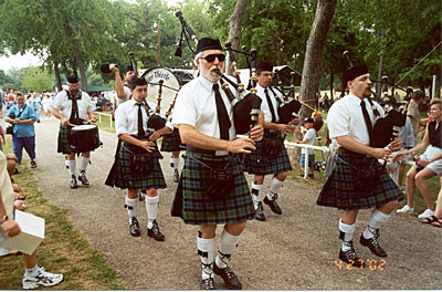 The exciting march through the park of the Silver Thistles on the way to their performance on stage.